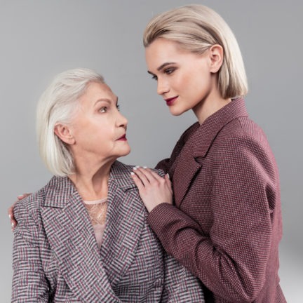 smiling appealing girl with dark lipstick looking directly into eyes